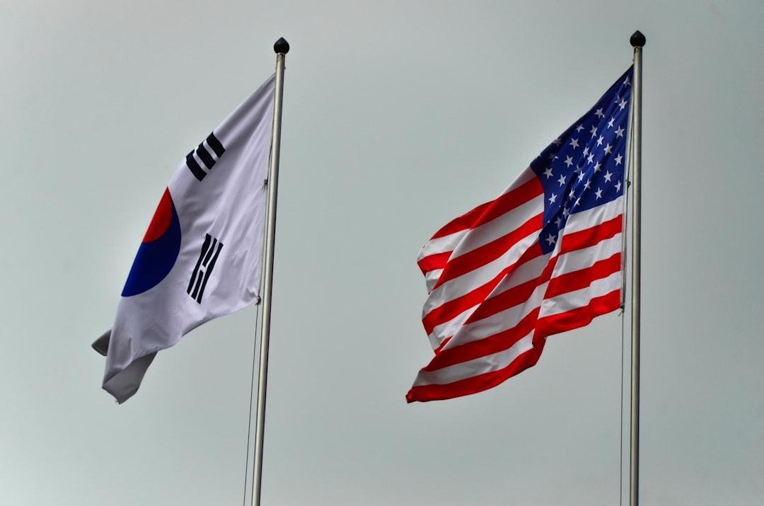 South korean and american flags flying