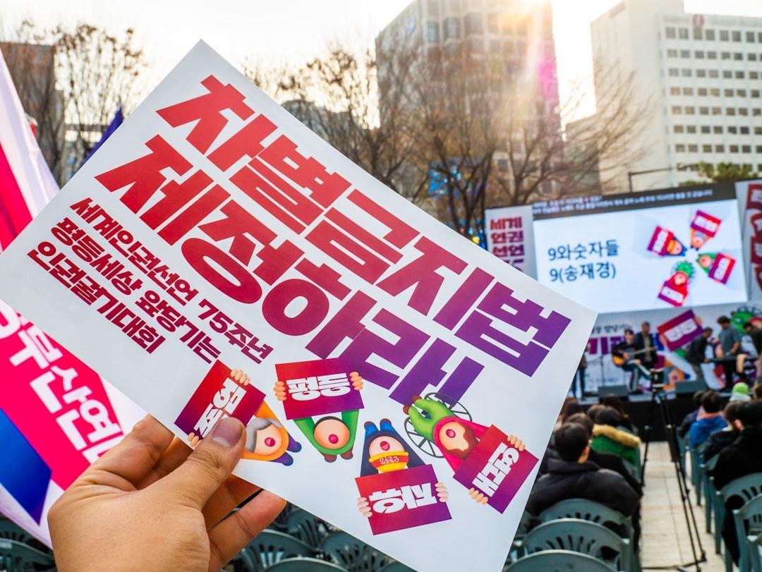 A person holding up a sign in front of a crowd