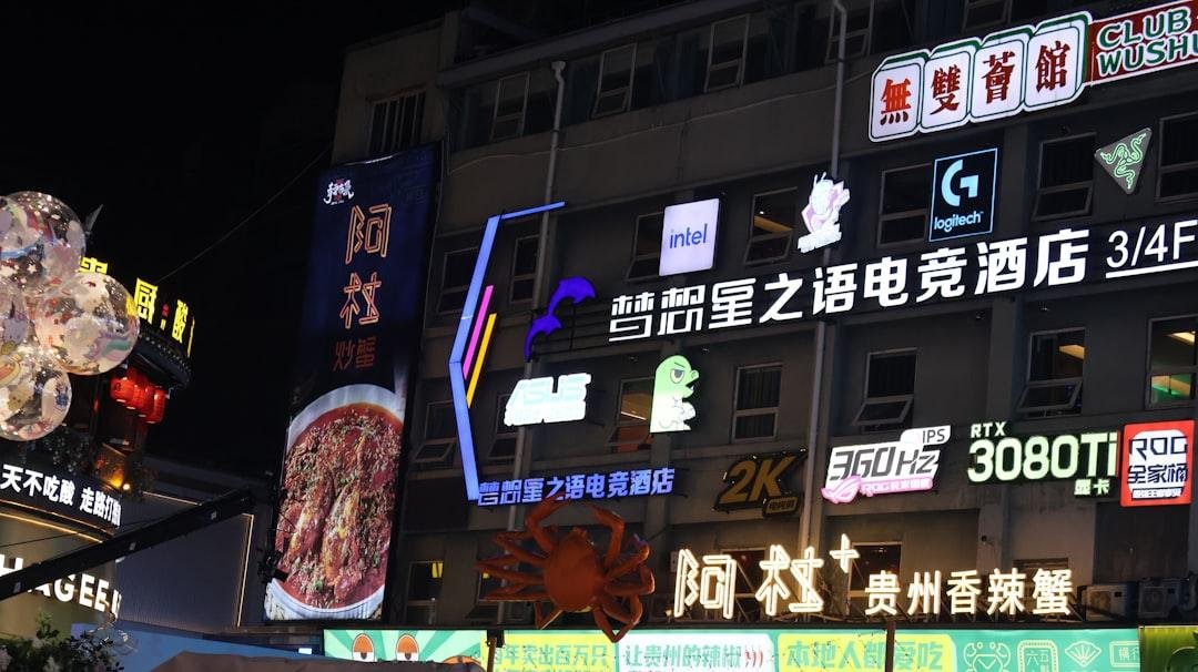 Bright neon signs illuminate a building at night.